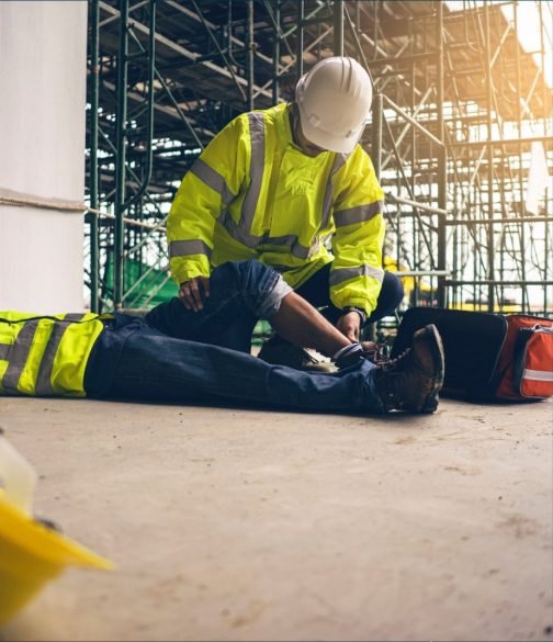 Construction workers helping an injured colleague on site